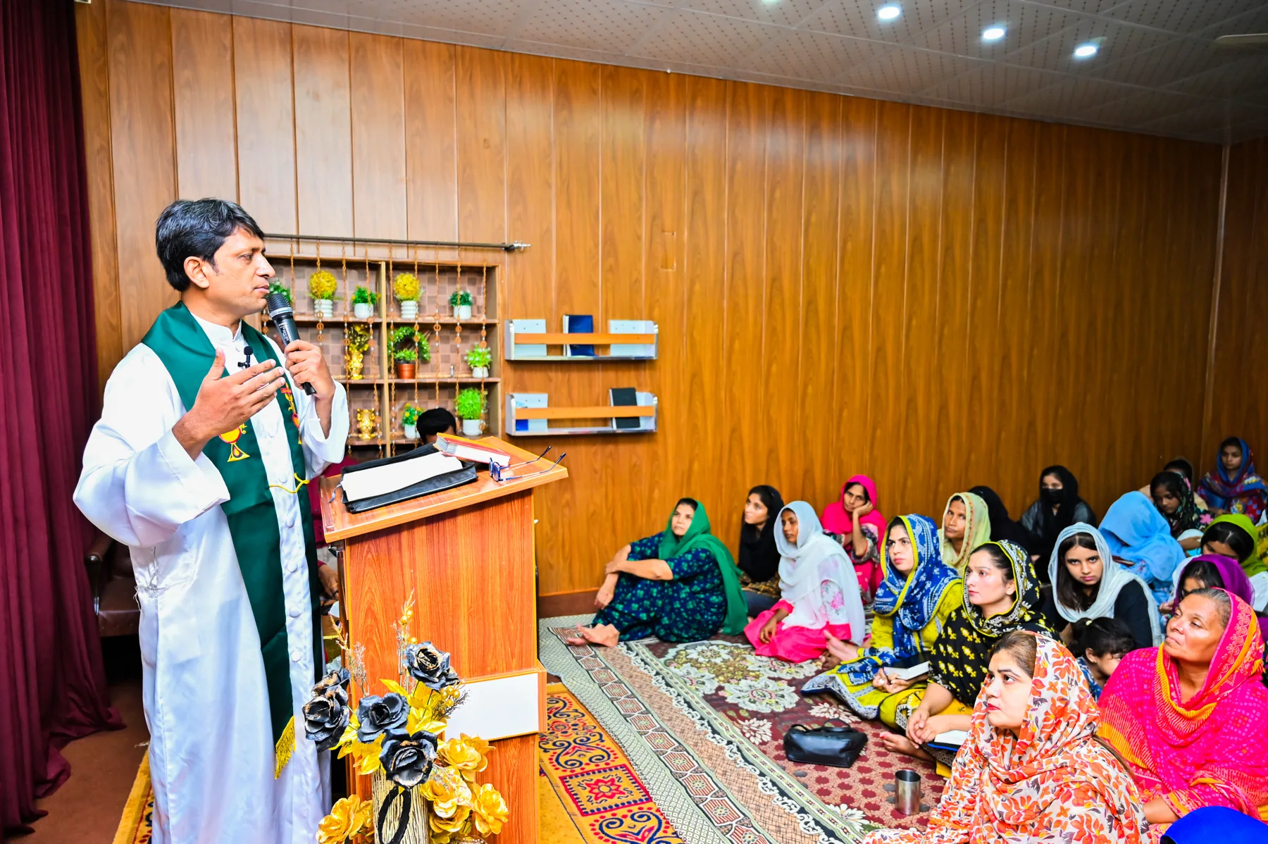 A church service with preaching and a seated congregation